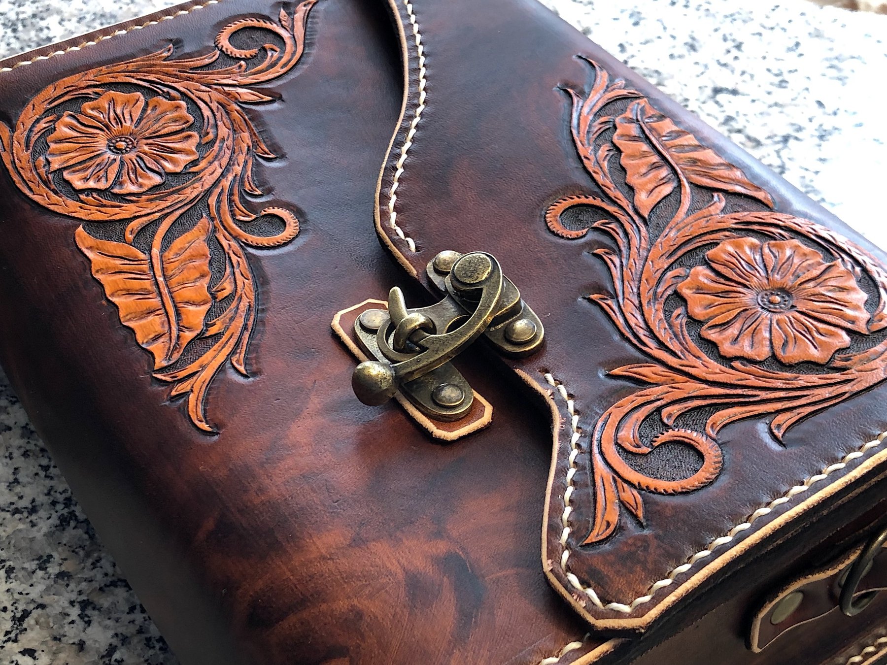 Macro of hand-carved floral leather tooling